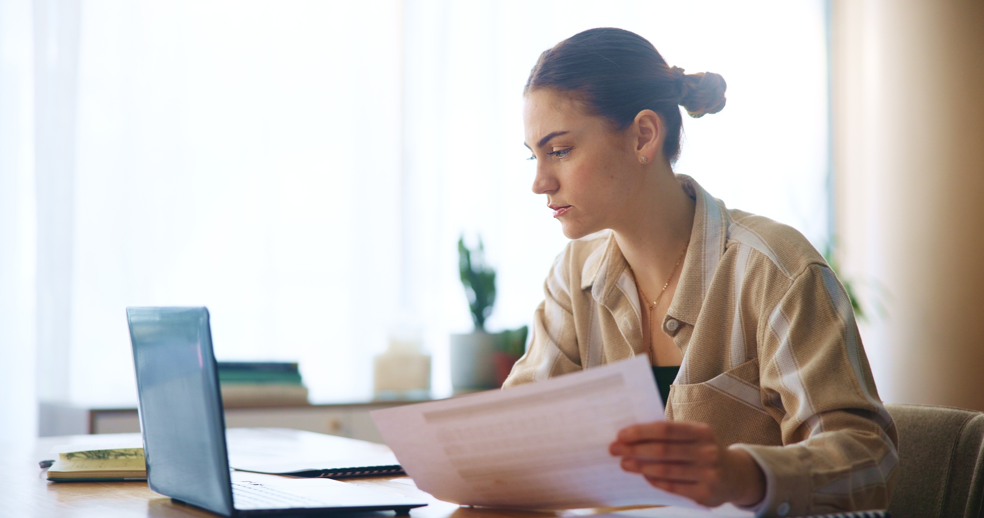 Girl, reading and laptop with document at house for loan approval, bank application and budget plan